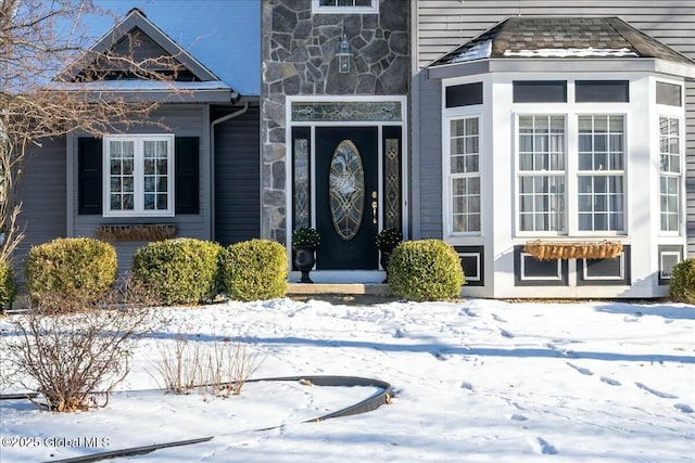 view of snow covered property entrance