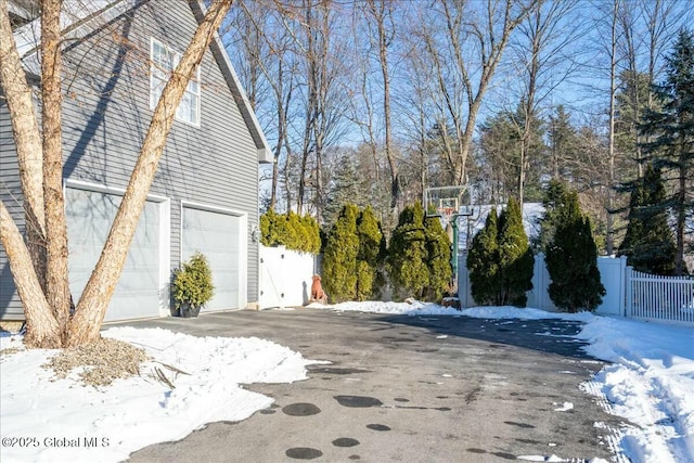 view of snow covered exterior with a garage