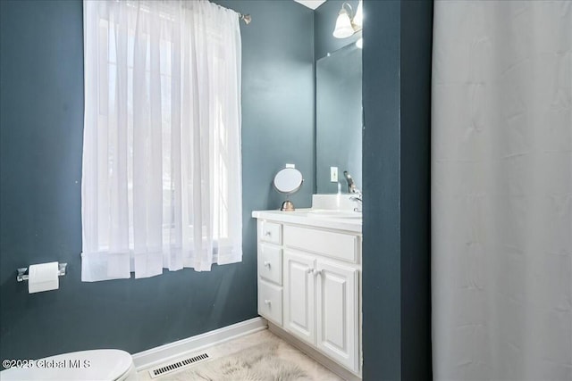 bathroom featuring vanity and toilet