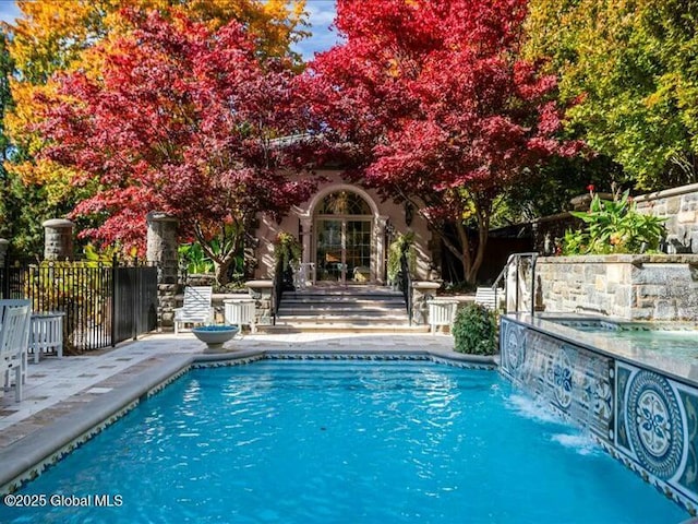 view of swimming pool featuring a fenced in pool, a patio area, and fence