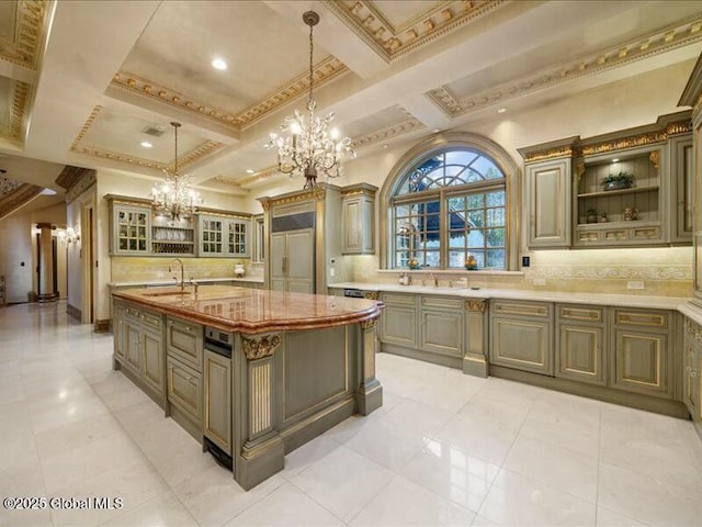 kitchen featuring coffered ceiling, hanging light fixtures, backsplash, glass insert cabinets, and an inviting chandelier