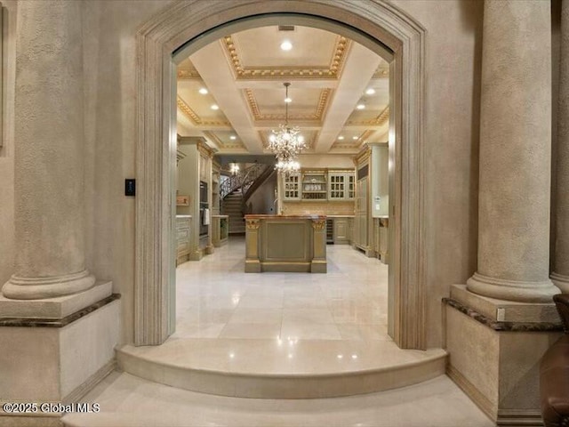 interior space with stairway, decorative columns, and arched walkways