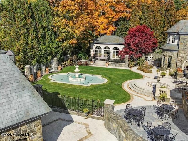 view of yard with a patio area, fence, and outdoor dining area