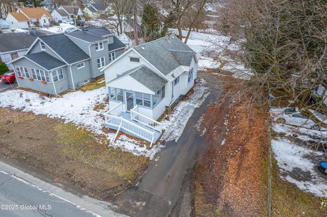 snowy aerial view featuring a residential view