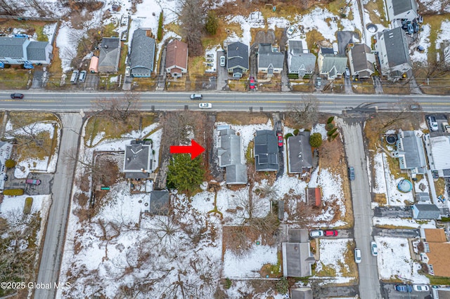 snowy aerial view with a residential view