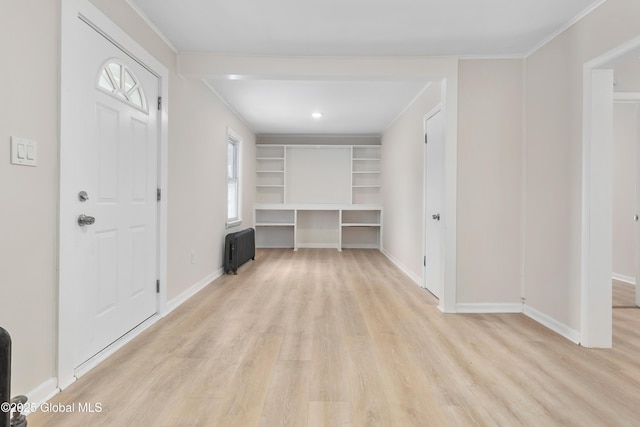 entrance foyer featuring light wood-style flooring, radiator heating unit, baseboards, and ornamental molding