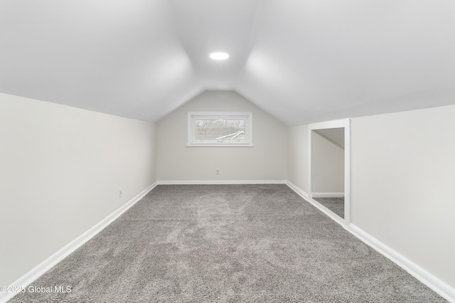 bonus room with vaulted ceiling, carpet, and baseboards