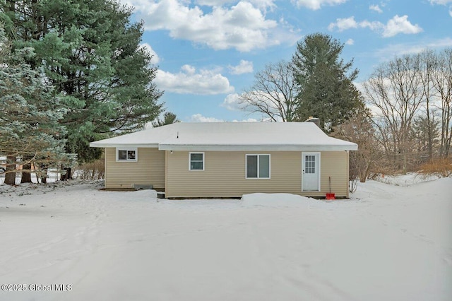 view of snow covered back of property