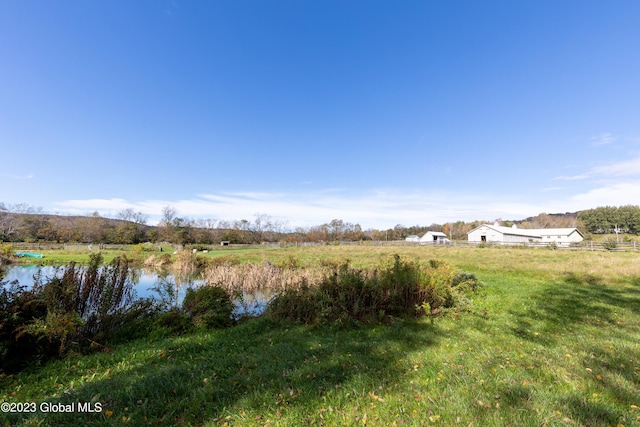 view of yard featuring a rural view and a water view