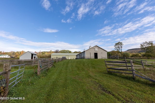 view of yard featuring an outbuilding and a rural view