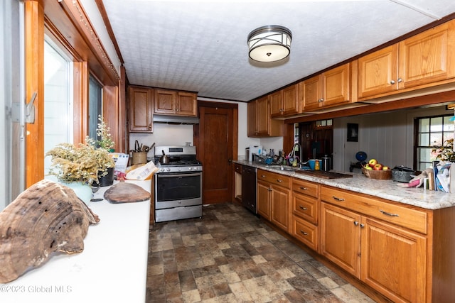 kitchen featuring ornamental molding, stainless steel range with gas cooktop, black dishwasher, and sink