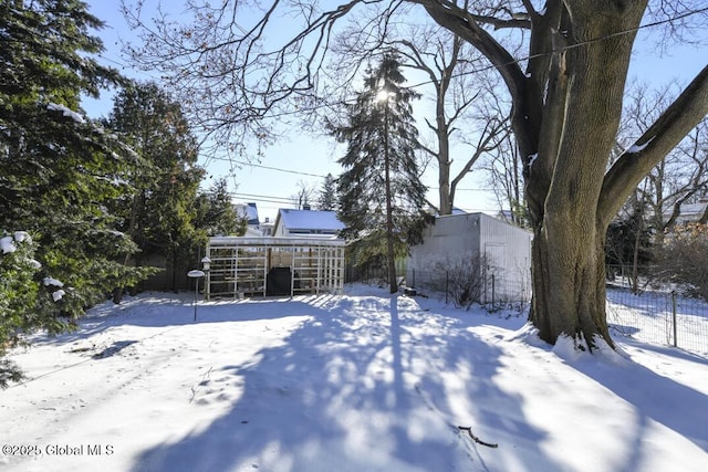 yard layered in snow with an outdoor structure