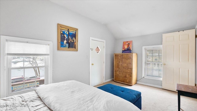 carpeted bedroom with vaulted ceiling