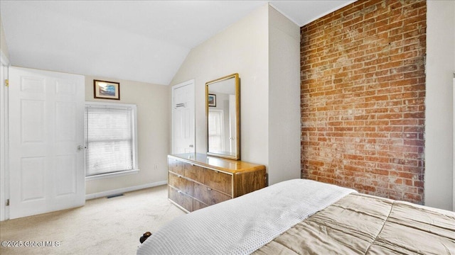 bedroom with vaulted ceiling and light carpet