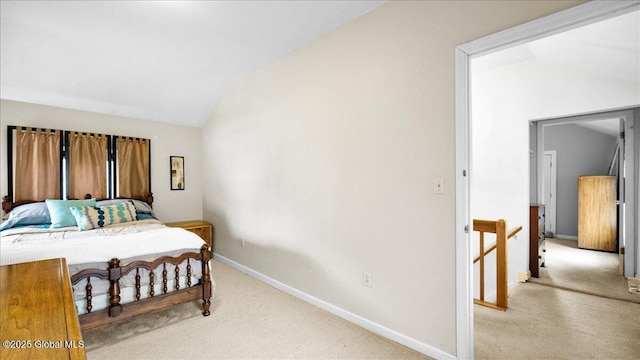 carpeted bedroom with lofted ceiling