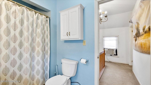 bathroom with cooling unit, toilet, and a shower with shower curtain