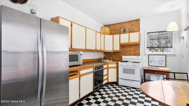 kitchen featuring white cabinetry, sink, tasteful backsplash, and stainless steel appliances