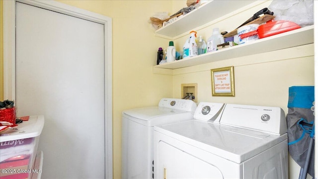 clothes washing area with washer and clothes dryer