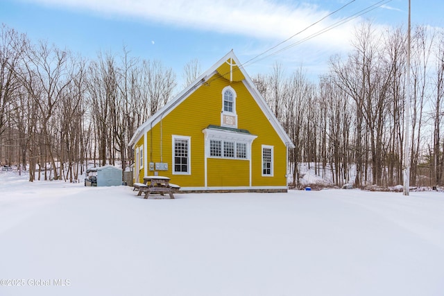 view of snow covered back of property