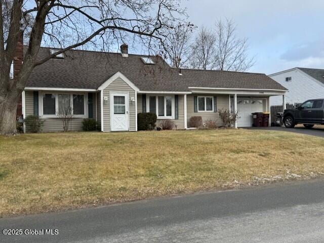 single story home featuring a garage and a front yard