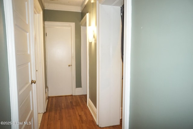 hall with hardwood / wood-style floors and ornamental molding