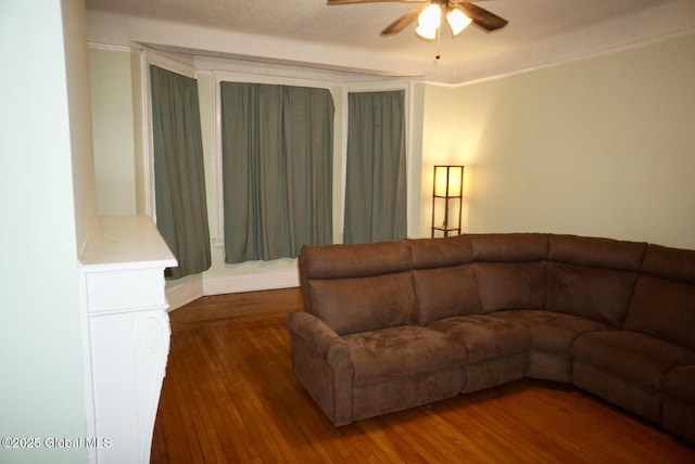 living room featuring dark hardwood / wood-style floors and ceiling fan