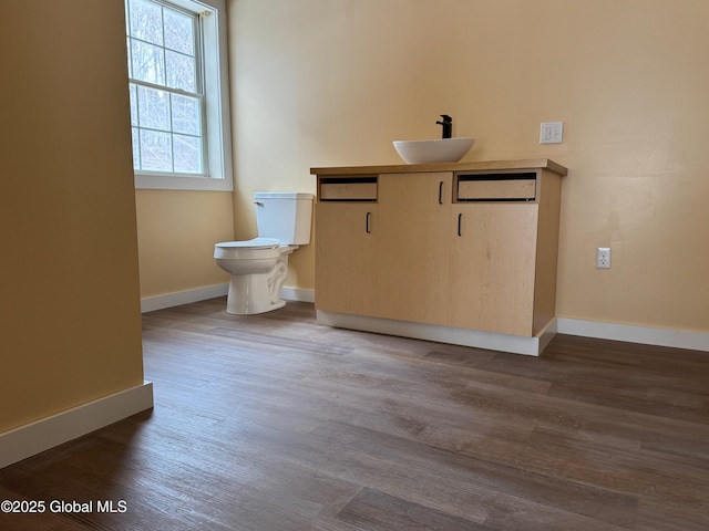 bathroom featuring hardwood / wood-style flooring, vanity, and toilet