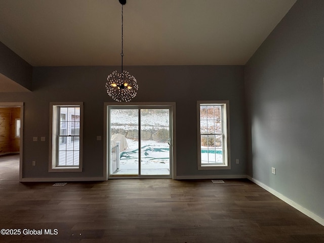 interior space featuring a notable chandelier and dark hardwood / wood-style flooring