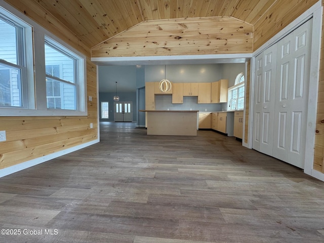 kitchen featuring a kitchen island, wooden walls, decorative light fixtures, hardwood / wood-style flooring, and wood ceiling