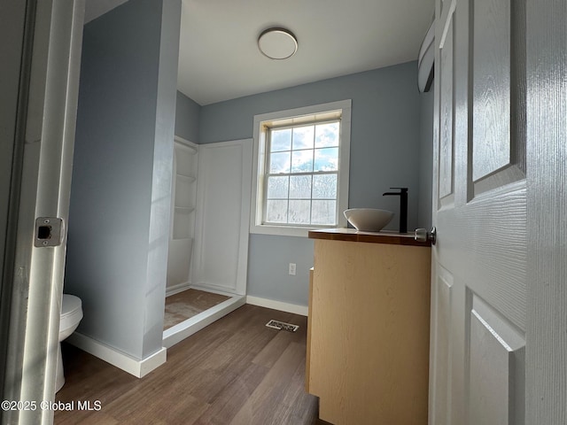 bathroom featuring hardwood / wood-style floors, sink, and toilet