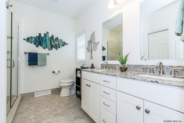 bathroom with vanity, an enclosed shower, and toilet