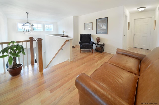 living room featuring an inviting chandelier and light hardwood / wood-style floors