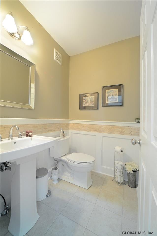 bathroom with tile patterned flooring, sink, and toilet