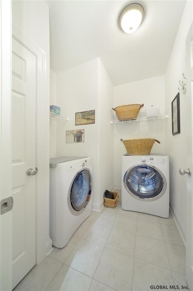 washroom with light tile patterned flooring and washer / clothes dryer