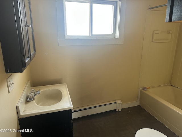 full bathroom featuring vanity, a baseboard heating unit, bathtub / shower combination, and toilet