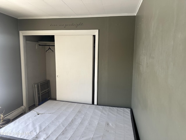 unfurnished bedroom featuring ornamental molding and a closet