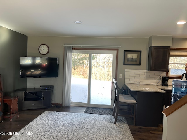 kitchen with dark hardwood / wood-style flooring and backsplash