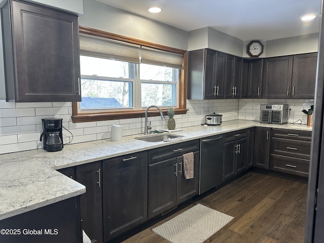 kitchen featuring black dishwasher, sink, decorative backsplash, light stone counters, and dark wood-type flooring