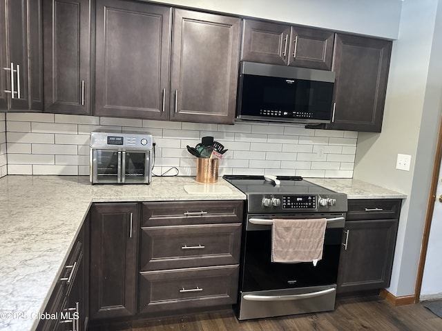 kitchen featuring tasteful backsplash, stainless steel appliances, dark hardwood / wood-style floors, and dark brown cabinets