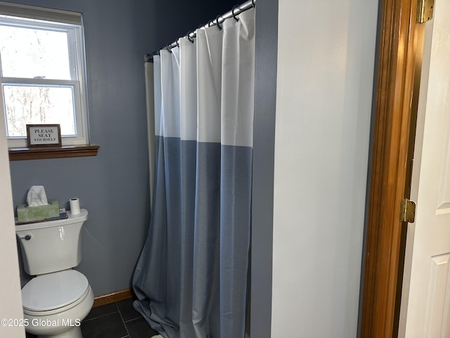 bathroom with tile patterned flooring, walk in shower, and toilet