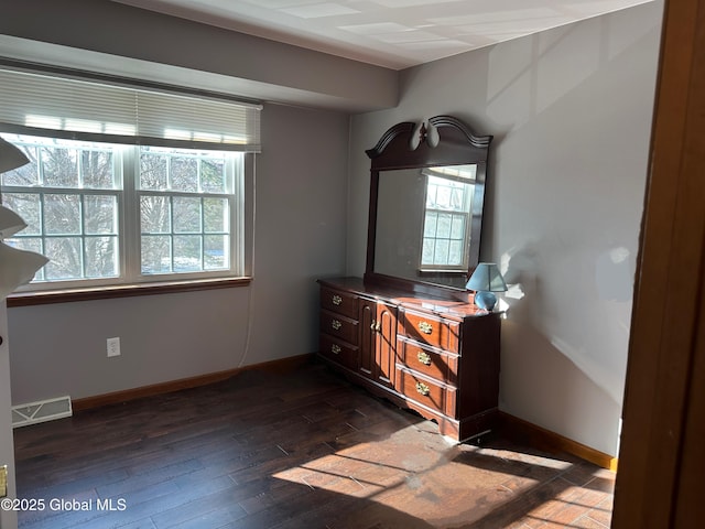 unfurnished bedroom featuring dark wood-type flooring