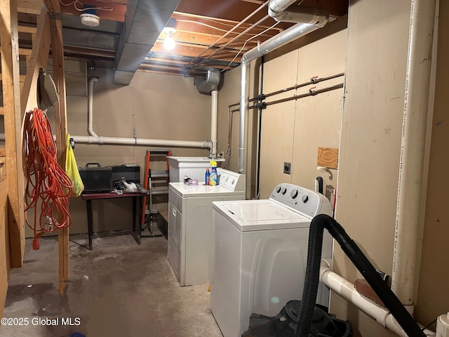 laundry area with separate washer and dryer and sink