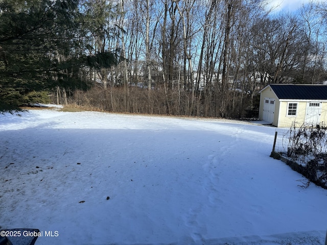 yard covered in snow with an outdoor structure