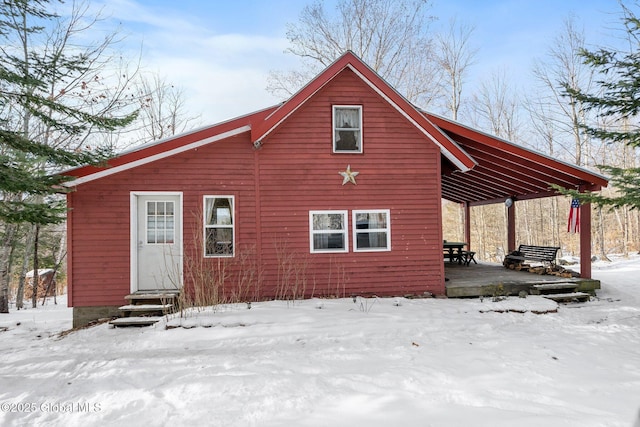 view of snow covered rear of property