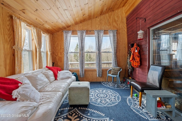 interior space featuring lofted ceiling, wood ceiling, and wooden walls