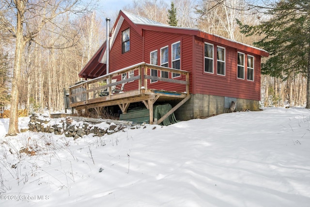 view of snow covered exterior with a deck