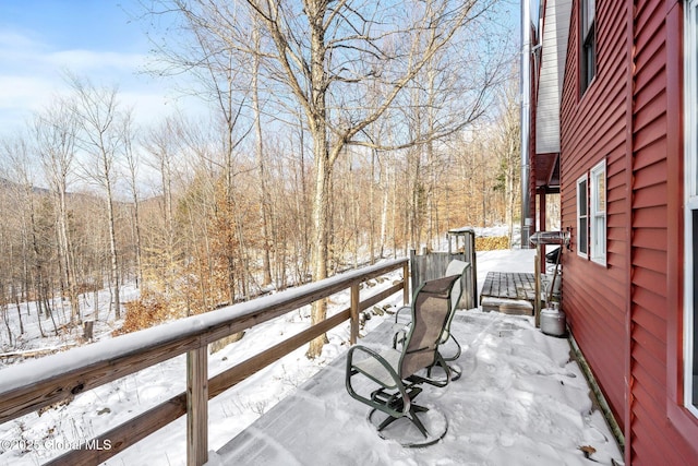 snow covered patio with a balcony