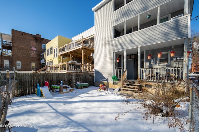 view of snow covered back of property