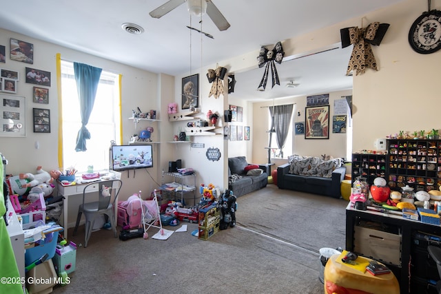 recreation room with ceiling fan and carpet