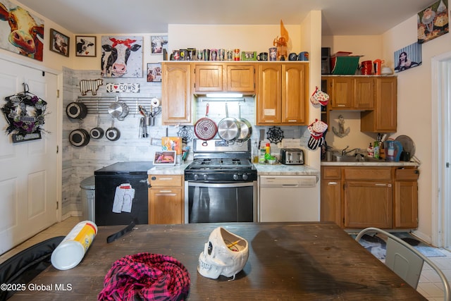 kitchen with tasteful backsplash, gas stove, fridge, and white dishwasher